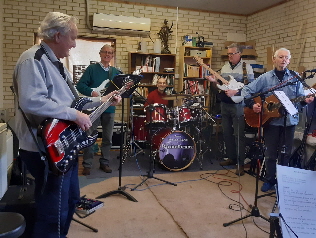 Four guitarists playing rock music