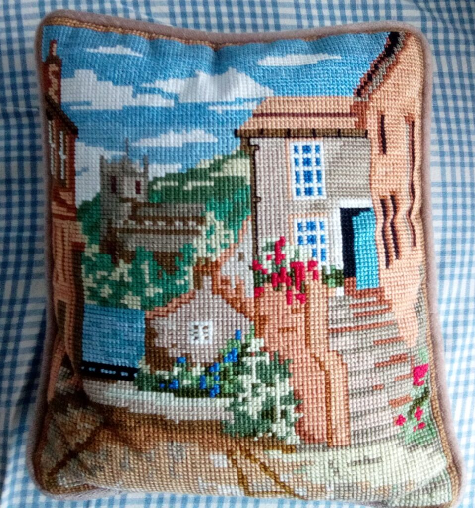 Cross stitch cushion entitled "A Church in a Cornish Creek"